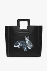 Black leather tote bag with top handle and custom cat illustration on front