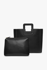 Black leather tote bag with detachable zip pouch in matching black