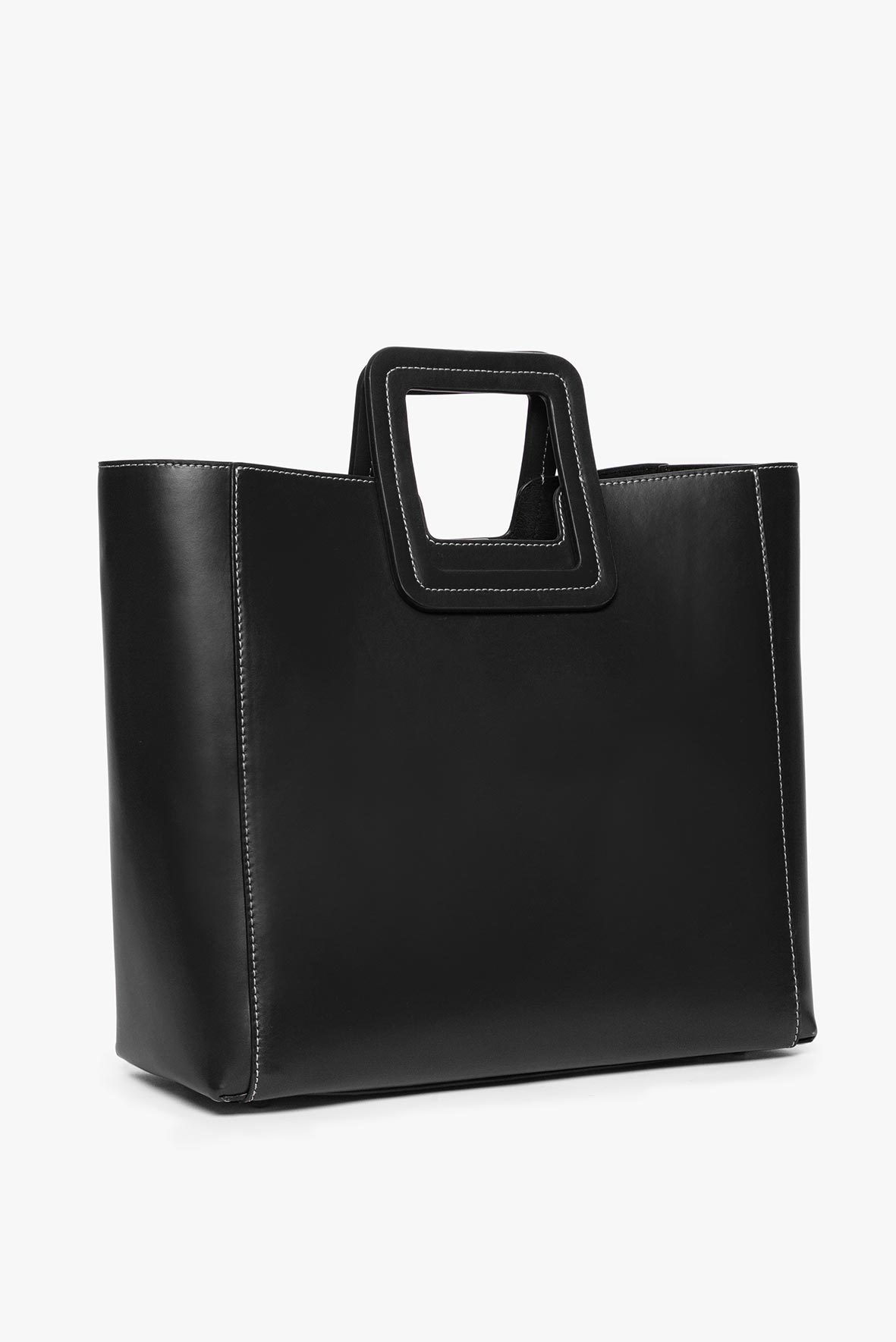 Black leather tote bag with top handle and stitched side panels