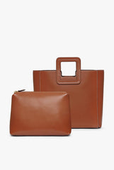 Tan leather bag with top handle and matching small zip pouch