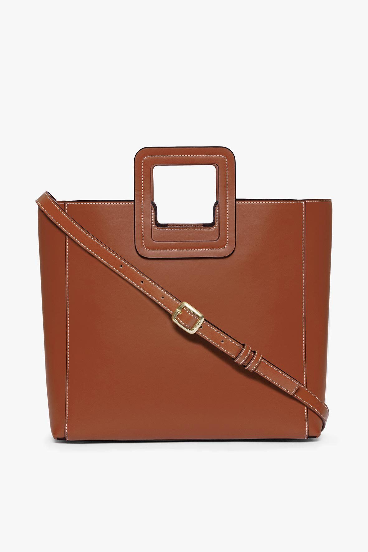 Tan leather bag with crossbody strap and metal buckle tab