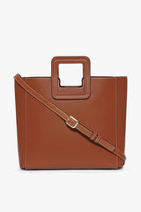 Tan leather bag with crossbody strap and metal buckle tab
