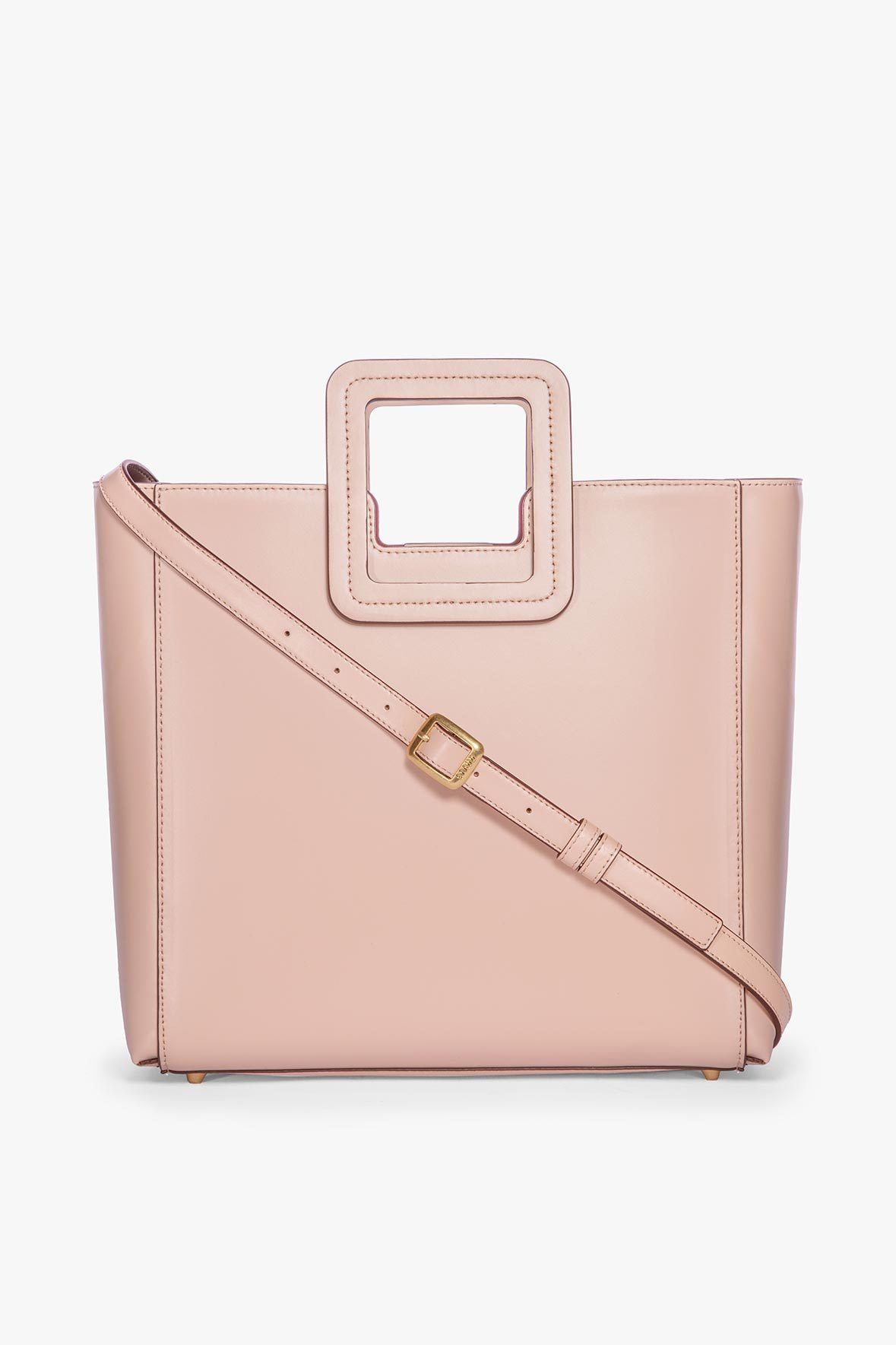 Blush leather tote bag with crossbody strap and gold buckle hardware