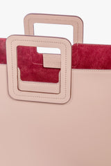 Blush leather tote bag with square top handles and contrast pink lining window