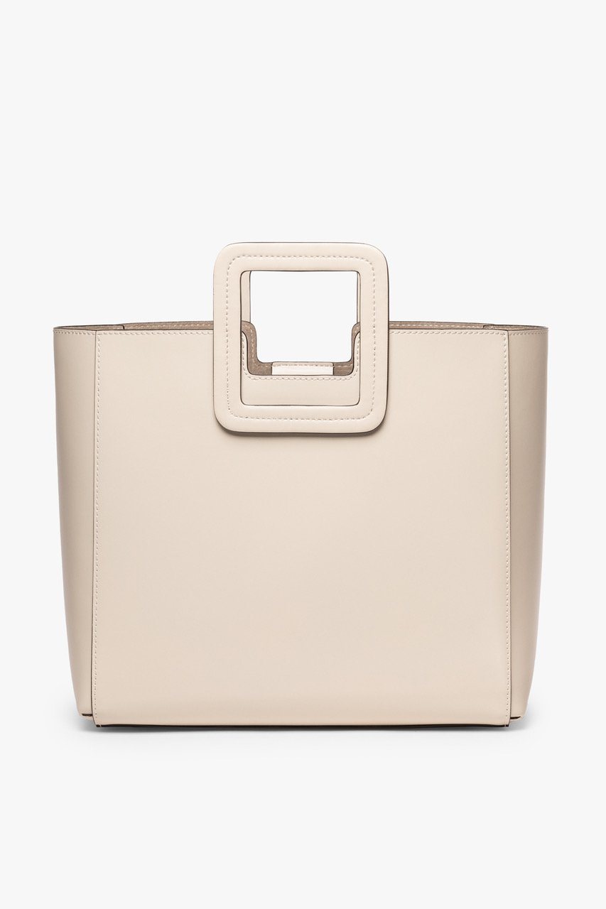Cream leather tote with top handle and clean, structured shape