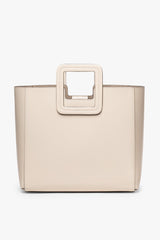 Cream leather tote with top handle and clean, structured shape