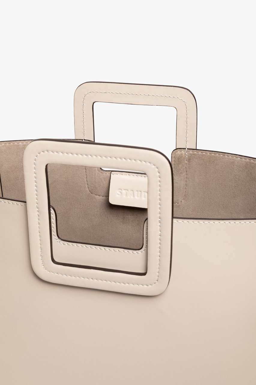 Cream leather bag front detail with square handle attachment