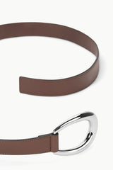 Mahogany brown leather wrap belt with oversized silver oval buckle, close-up