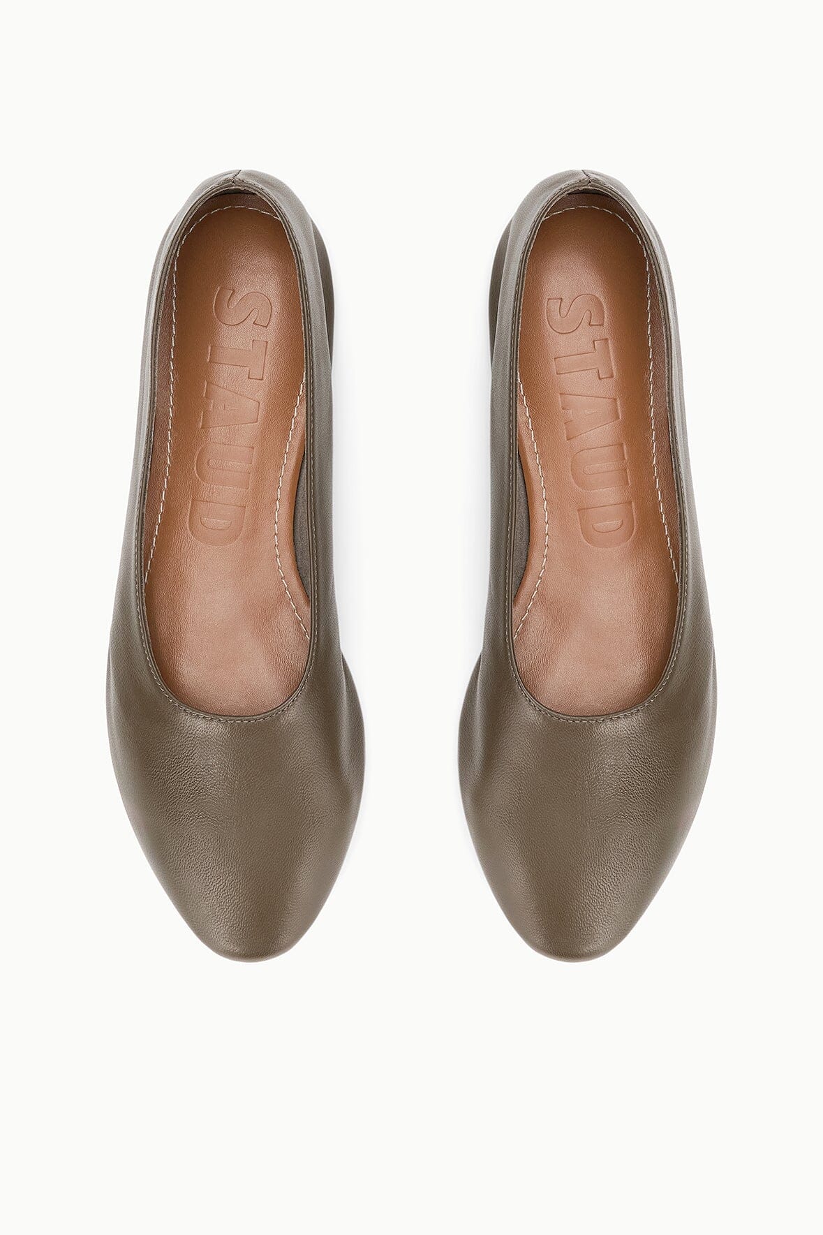 Pair of truffle-brown ballet flats showing interior and stitched opening