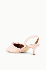 Pink ballet slingback pump with bow at toe and ankle strap, side view.