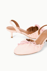 Pink ballet slingback heels with gathered ruffle vamp and bow detail.