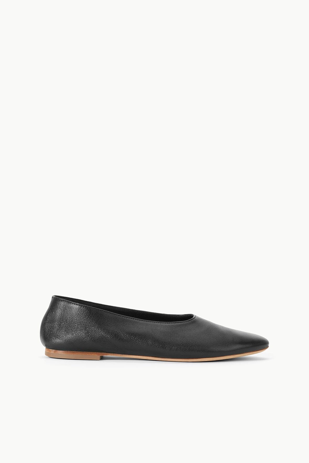 Black ballet flat with rounded toe and tan outsole
