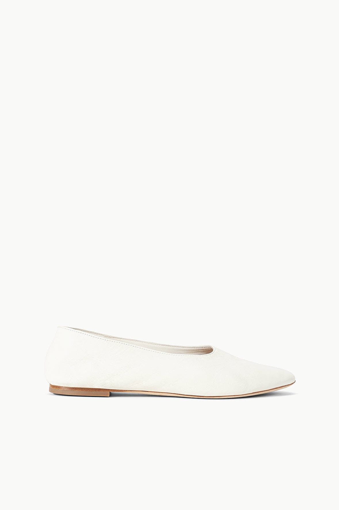 Cream paper ballet flat with rounded toe and flat brown-trimmed sole