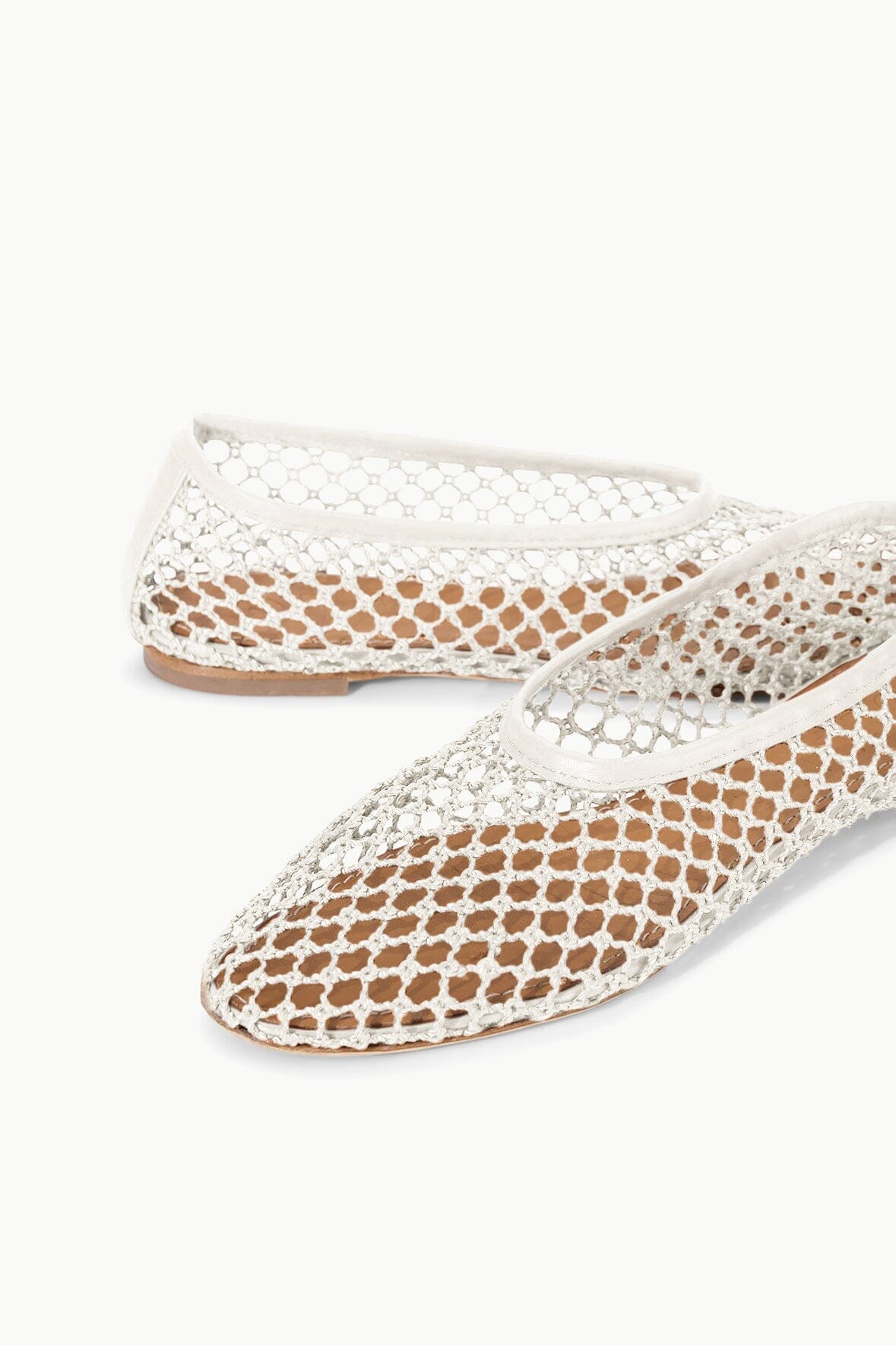 Paper netting ballet flats, light cream mesh upper with rounded toe and low rubber sole.