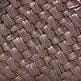 Close-up of woven raffia texture in dark brown with visible strap fibers