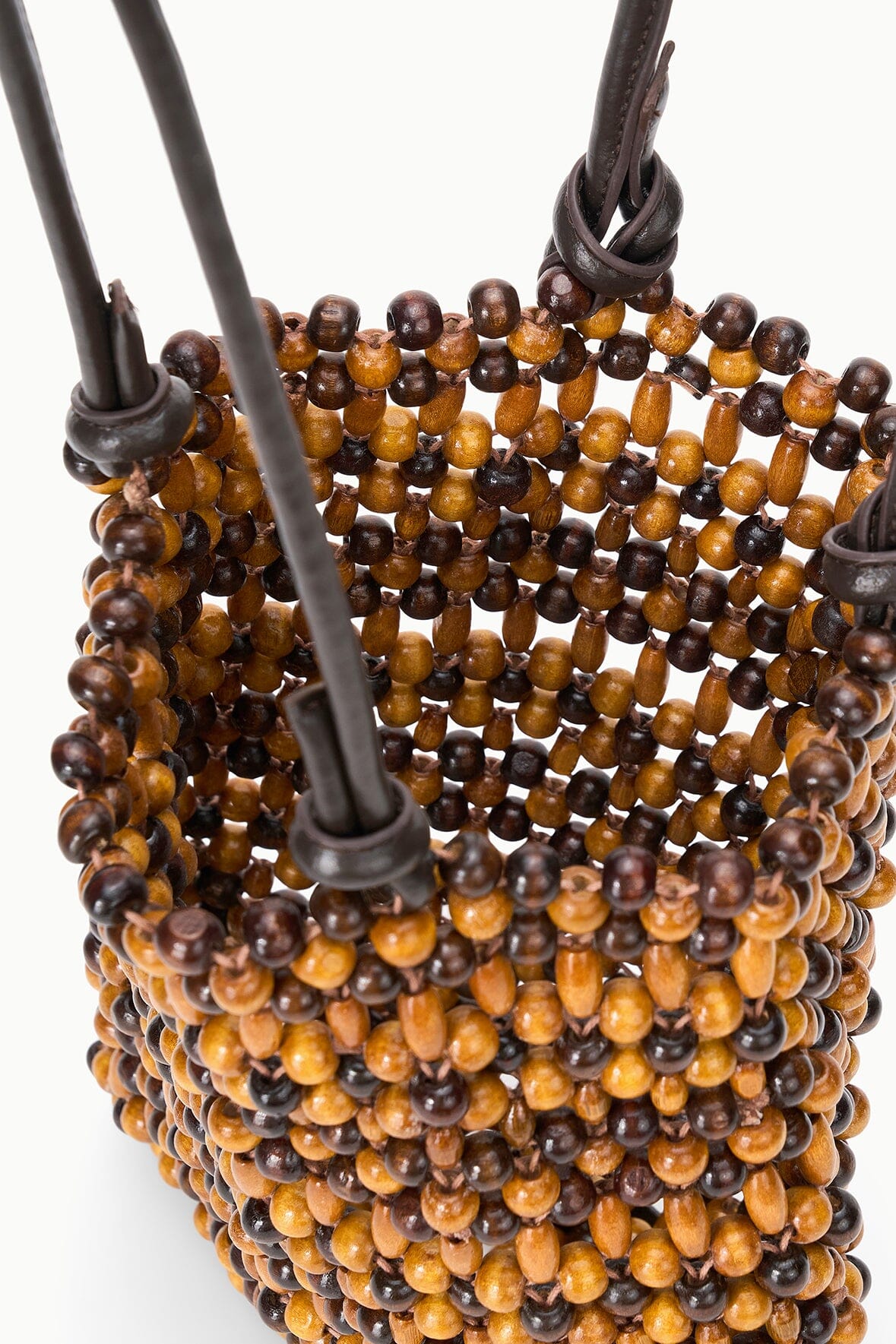 Close-up of multi wood bead mini tote with curved edge and top handle straps