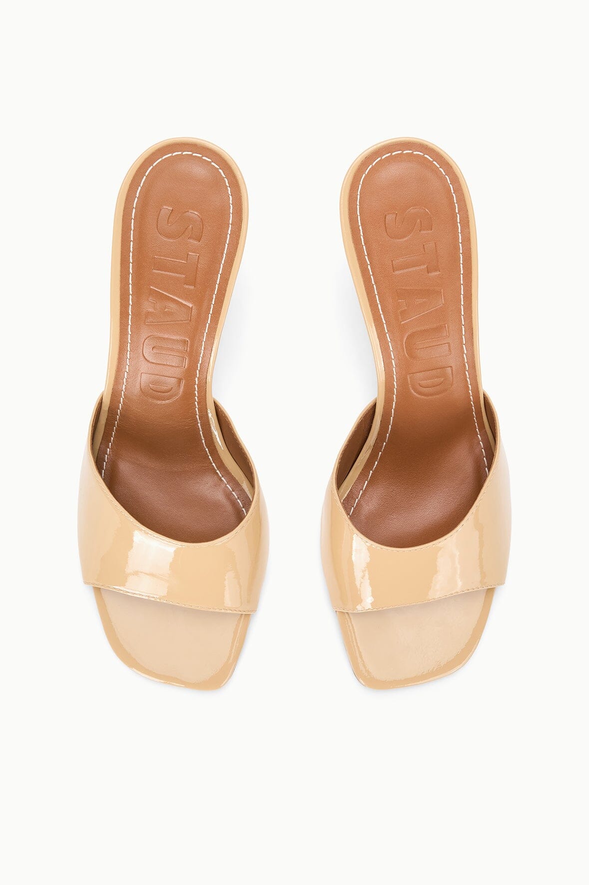 Tan patent leather mule with open toe; view of inside footbed and logo sole
