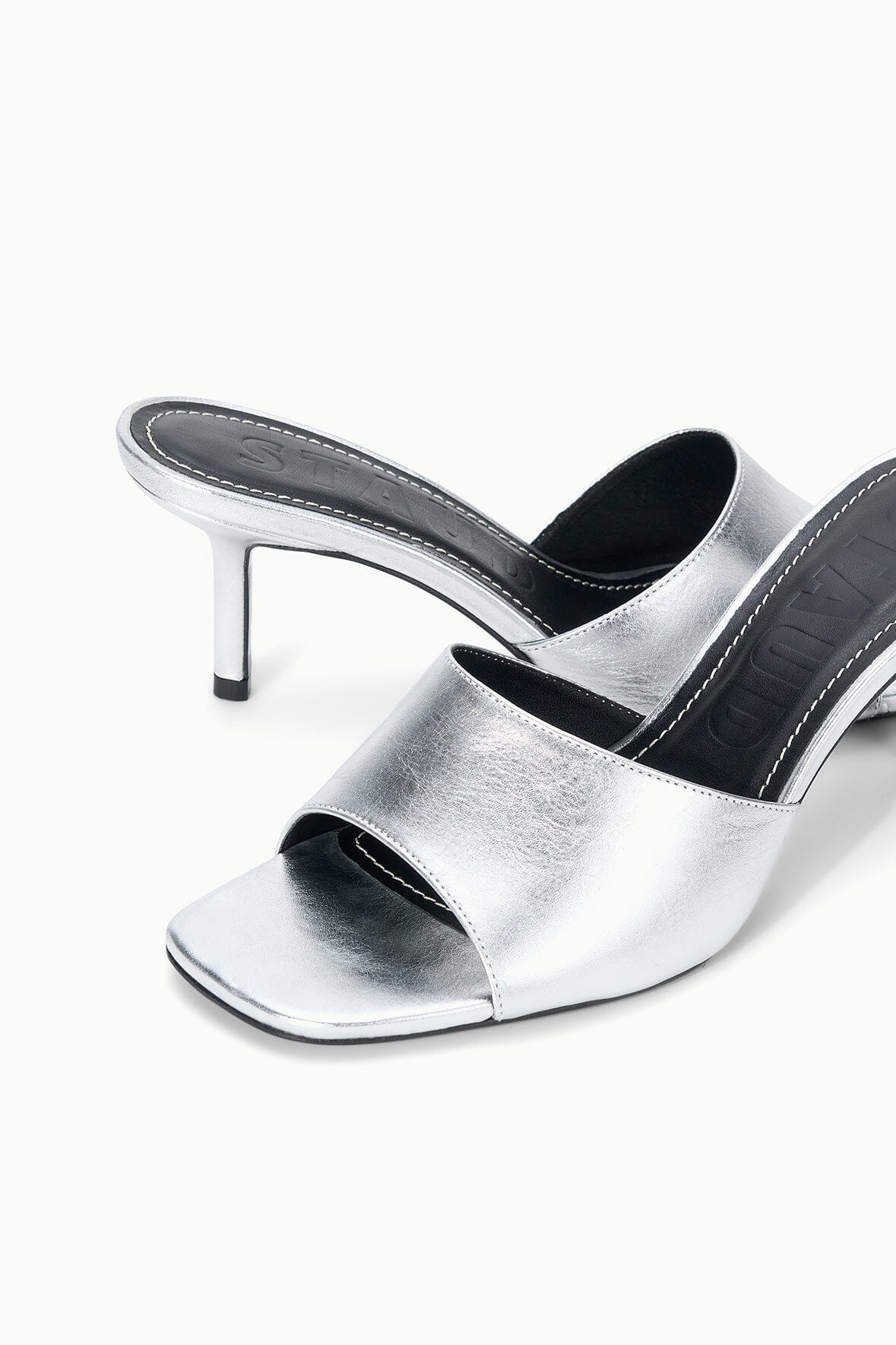 Silver mule sandals with open toe and stiletto heel