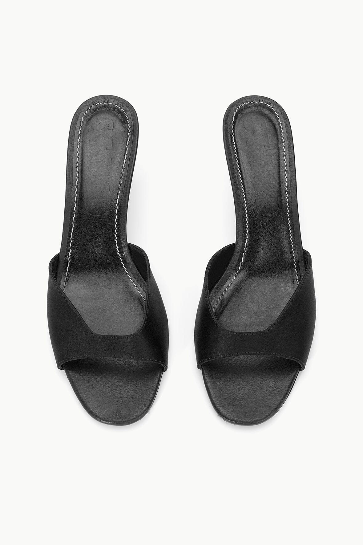 Pair of black satin open-toe mule sandals with slingback heel and stitching