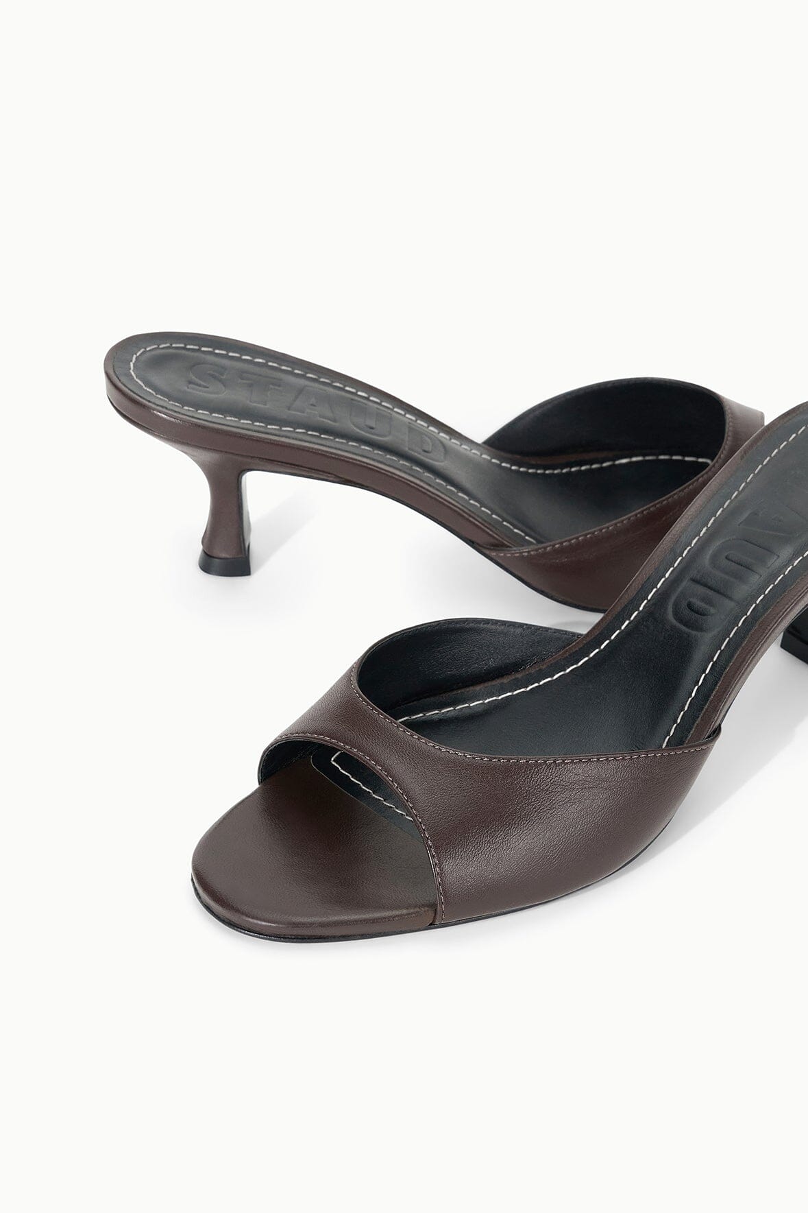 Espresso brown leather mule slides with open toe and mid heel, close-up detail.