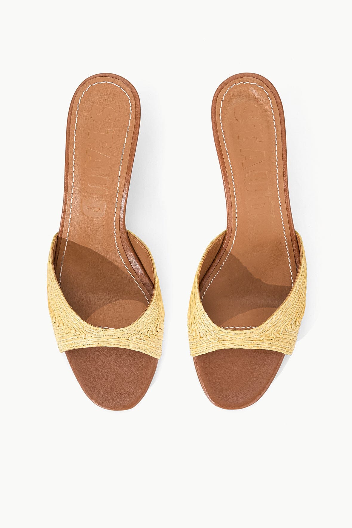 Pair of natural raffia open-toe mule sandals with tan leather lining