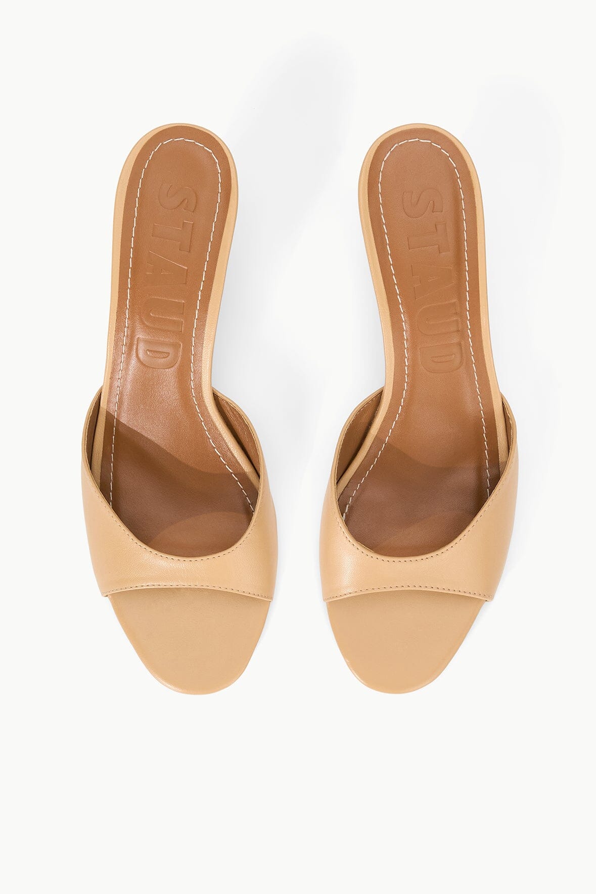 Tan leather open-toe mules with cushioned footbed, shown as a pair.