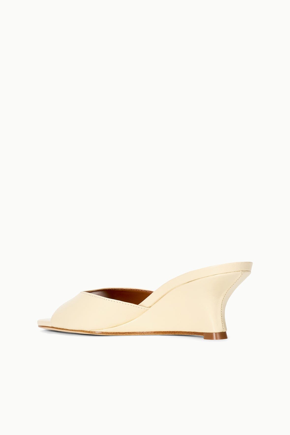 Cream wedge slide sandals with open toe and curved platform heel
