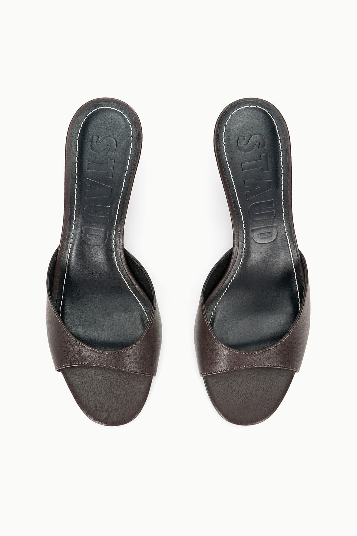 Pair of espresso brown wedge sandals with open toe and textured footbed