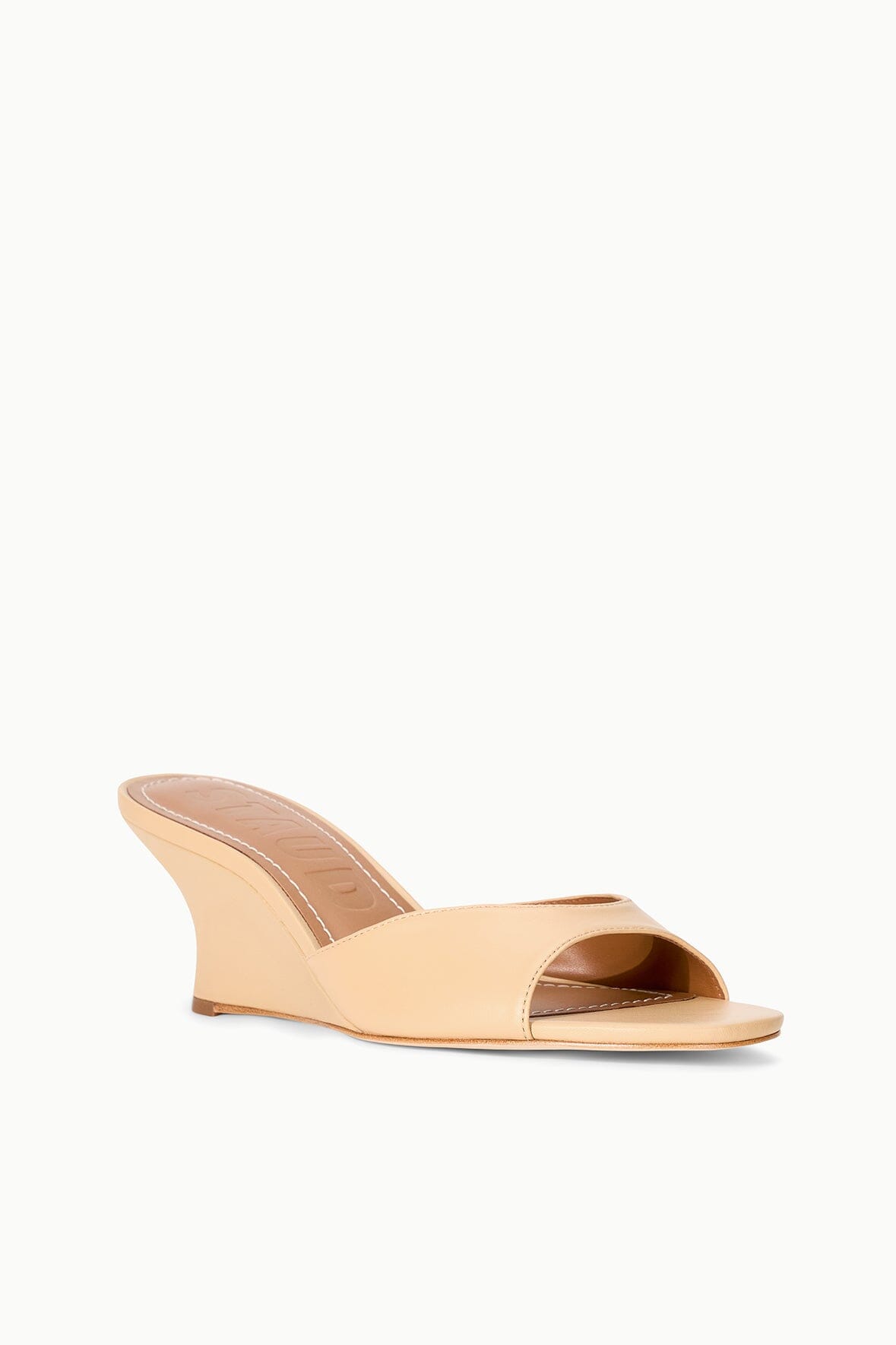 Tan wedge slide sandals with open toe and curved wedge heel