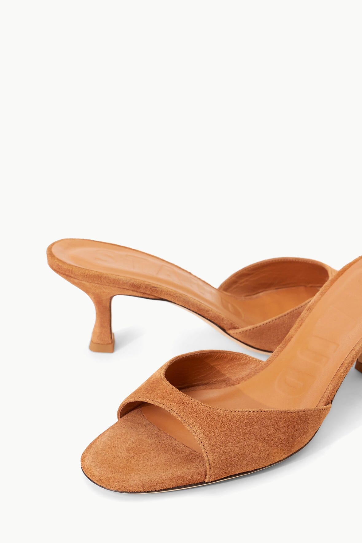 Tan suede mule with open toe and textured vamp detail