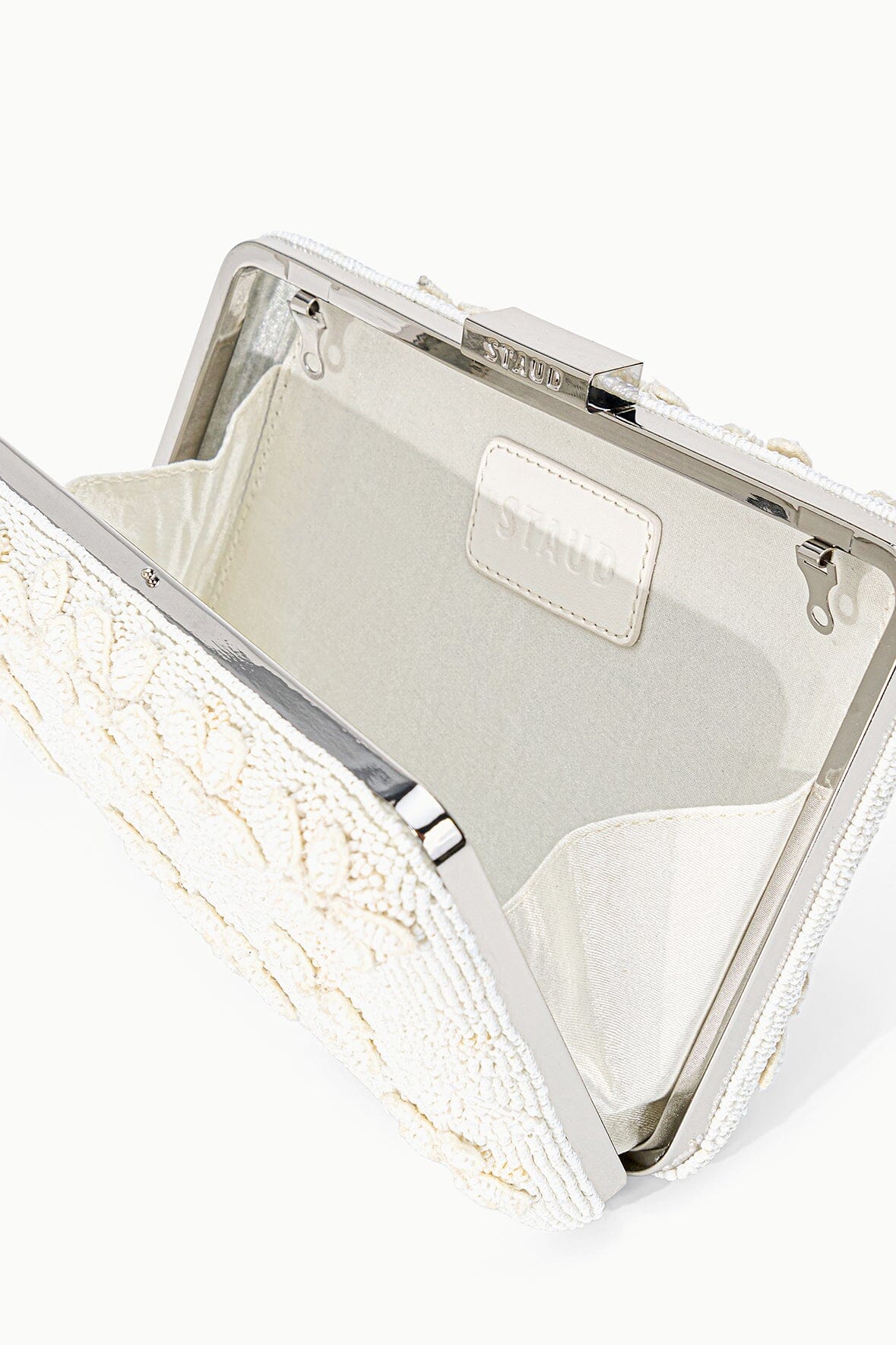 Open off-white beaded clutch with fabric lining and inner slip pocket