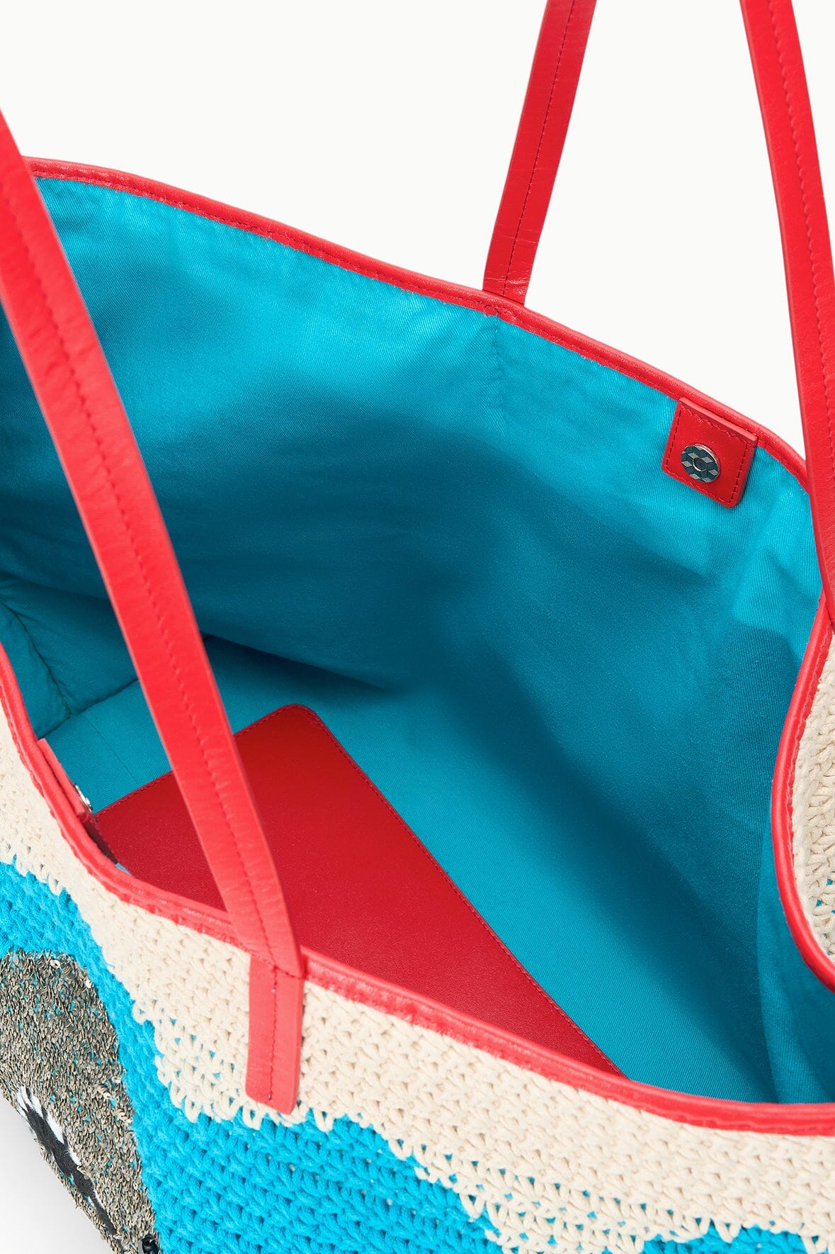 Interior view of blue-and-cream tote bag with red trim and red handle seams