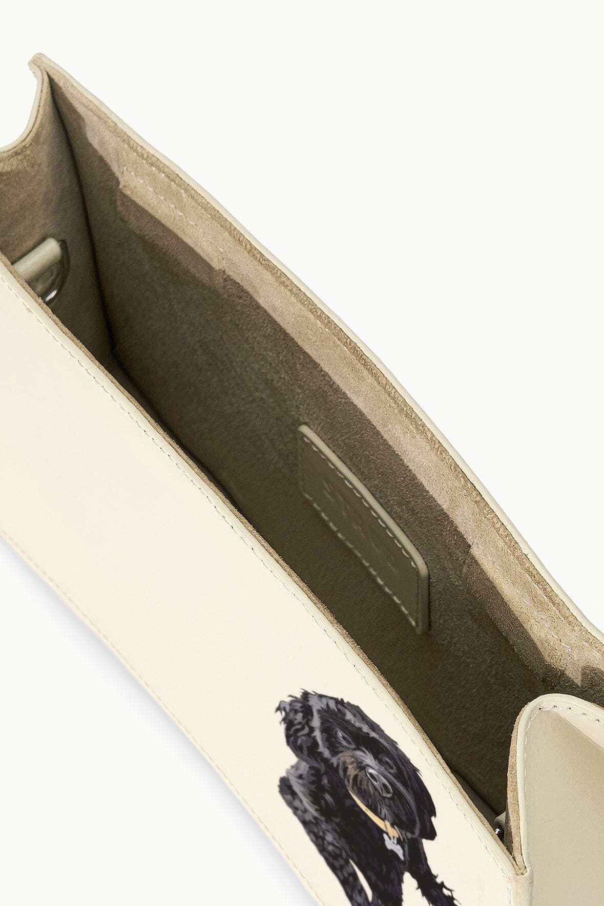 Cream shoulder bag interior with dark lining and stitched pocket
