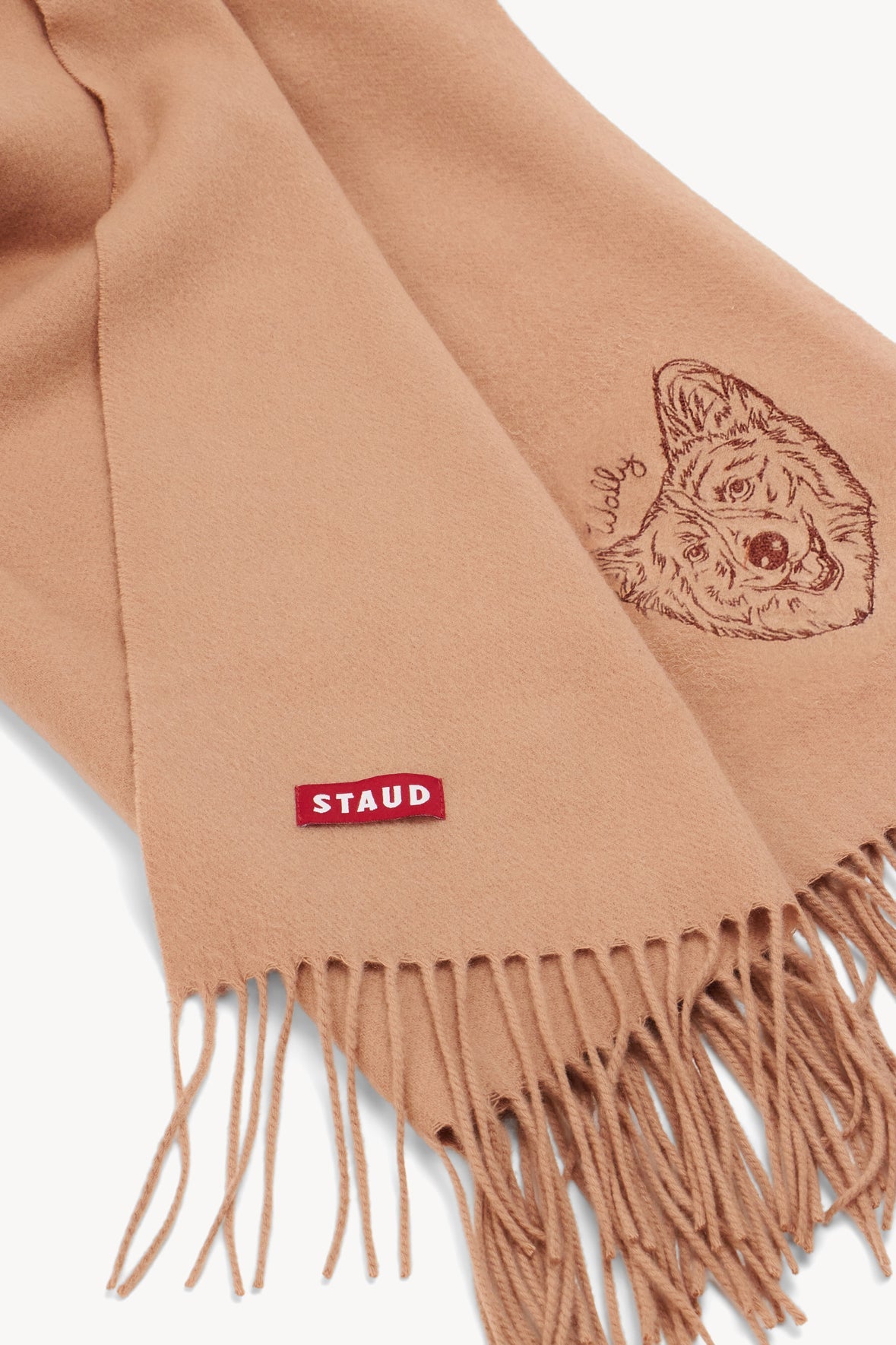 Camel cashmere blanket detail with embroidered crest and fringe edge