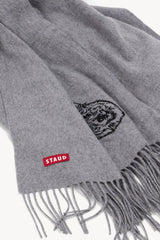 Grey cashmere blanket detail with embroidered crest and fringe edge