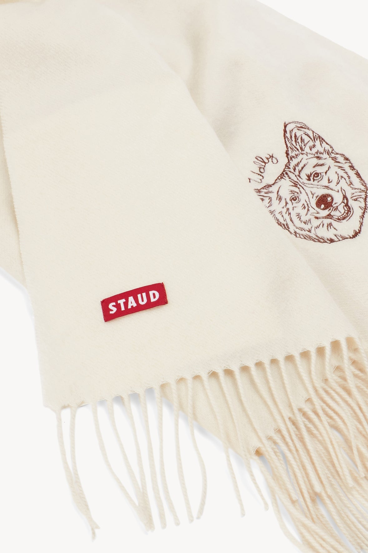 Ivory cashmere blanket corner with embroidered dog and STAUD logo patch