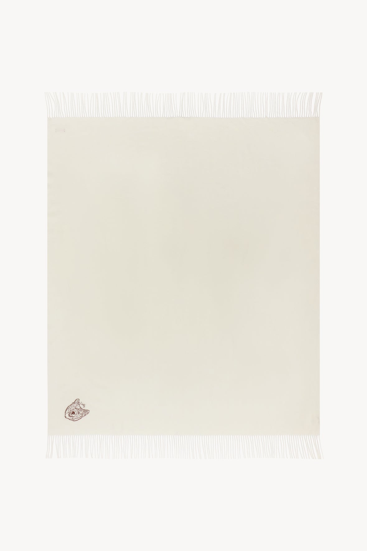 Ivory cashmere blanket with small embroidered dog emblem and fringed border