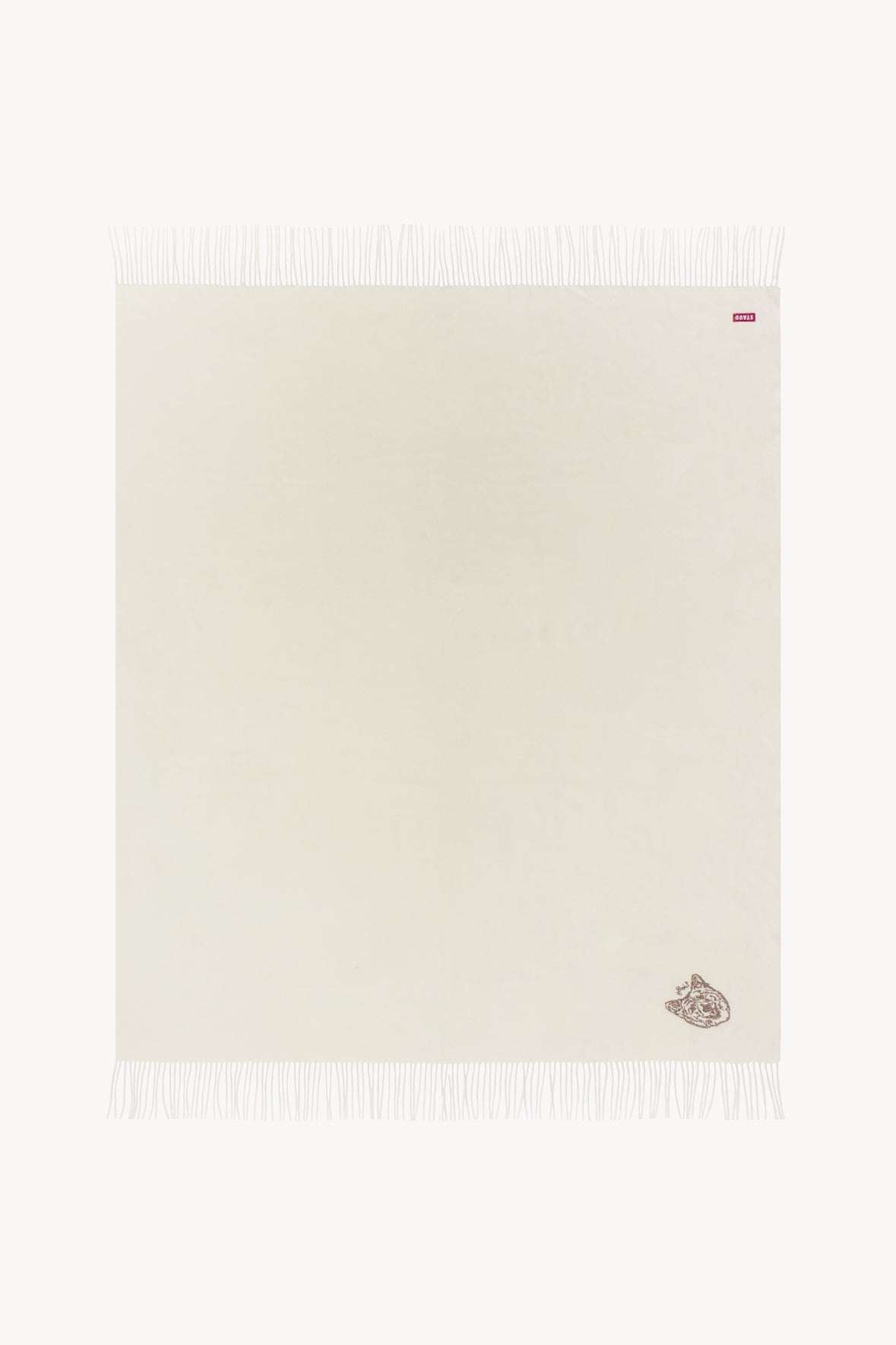 Ivory cashmere blanket with small dog emblem and light fringed border