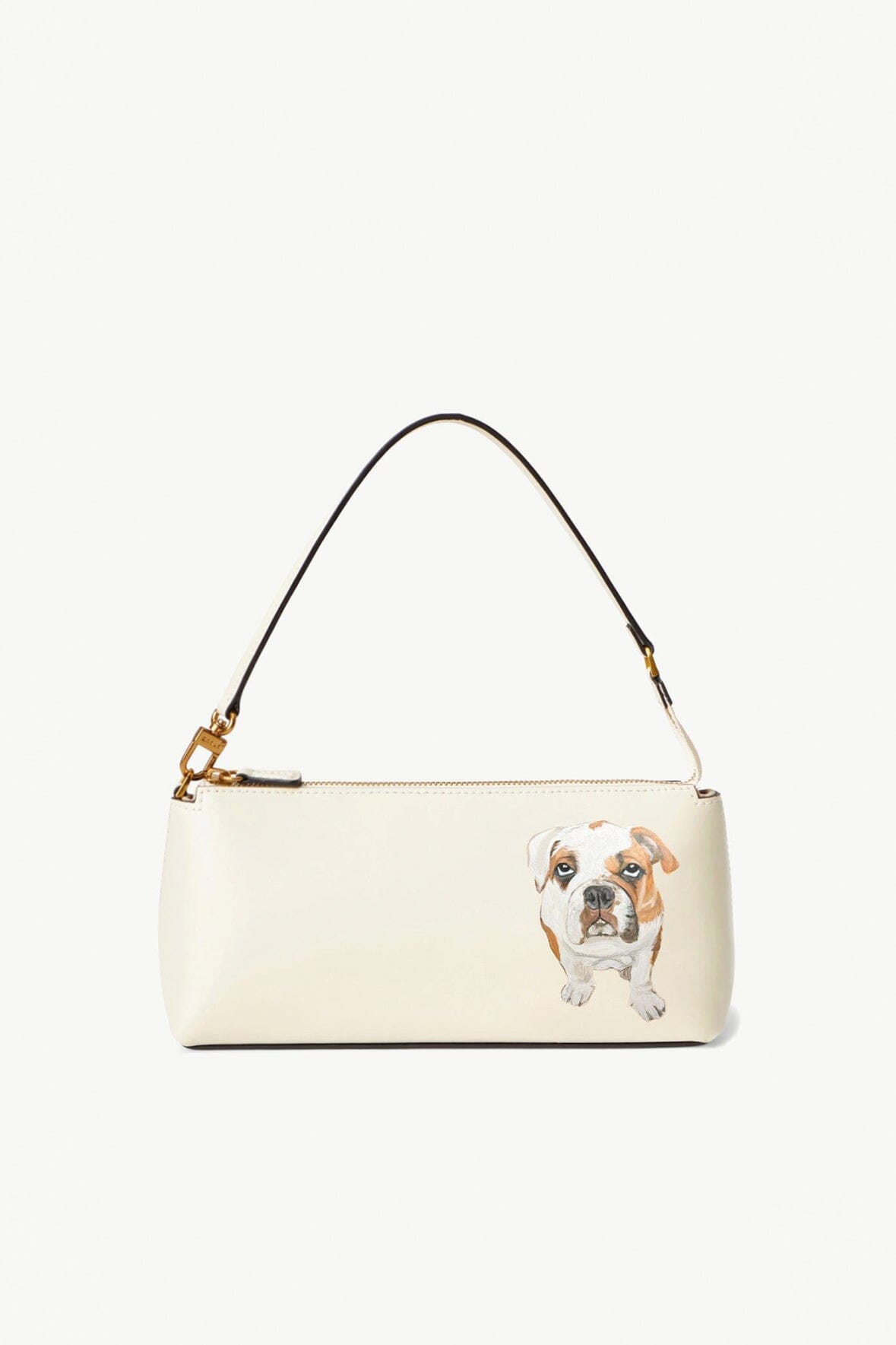 Cream shoulder bag with dog portrait patch on front and gold hardware