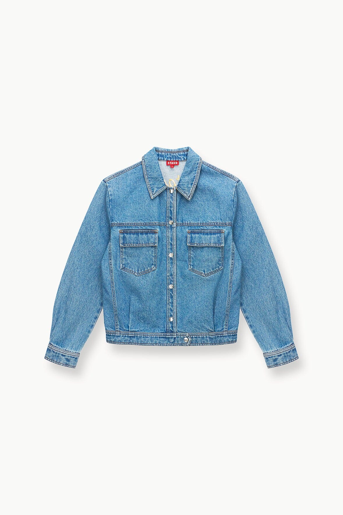 Medium-wash denim jacket with button front, pointed collar, and flap chest pockets