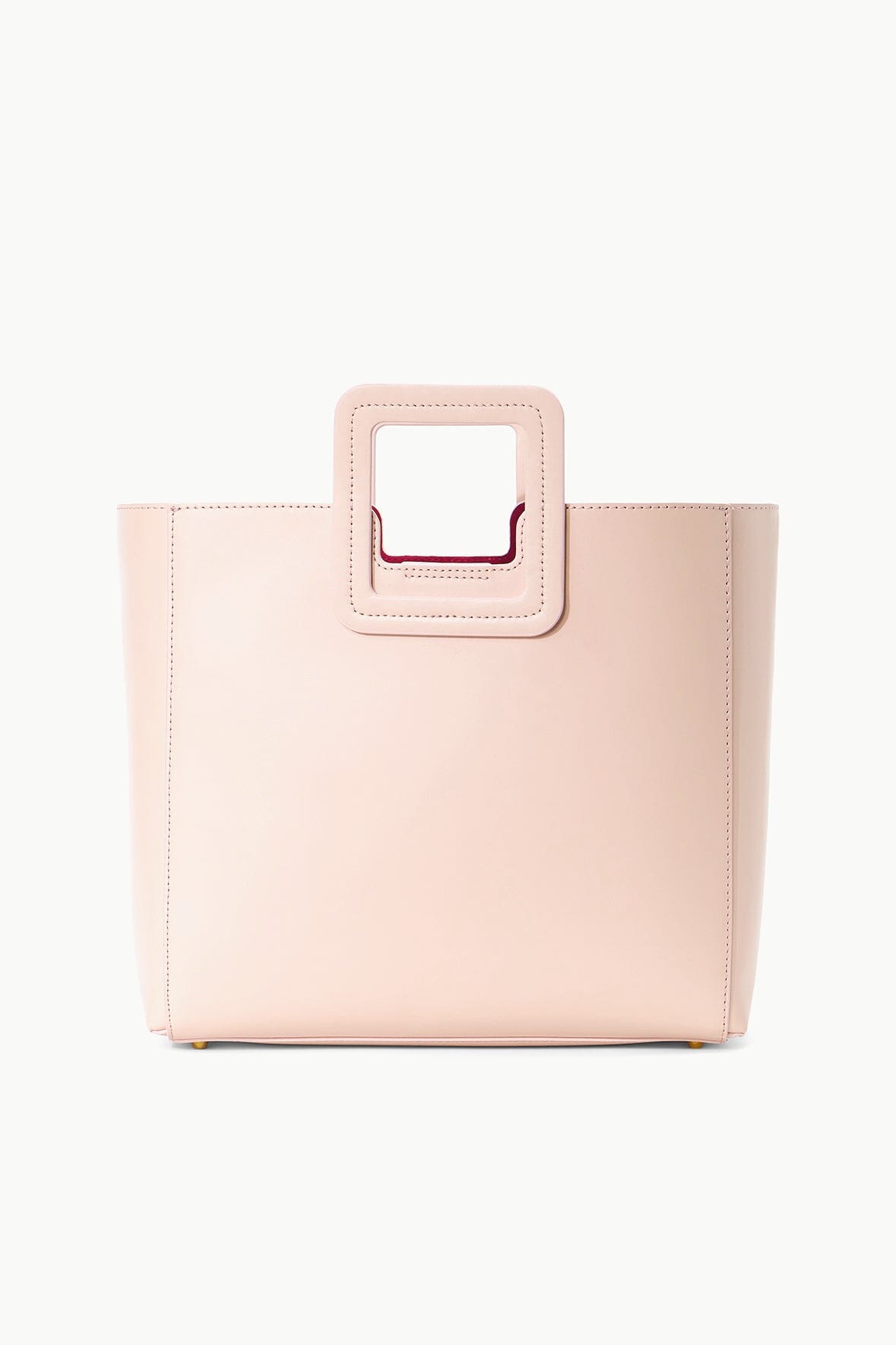 Blush leather tote bag with square top handle and front patch