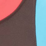 Close-up of dark chocolate one-piece swimsuit fabric with pink edge stitching