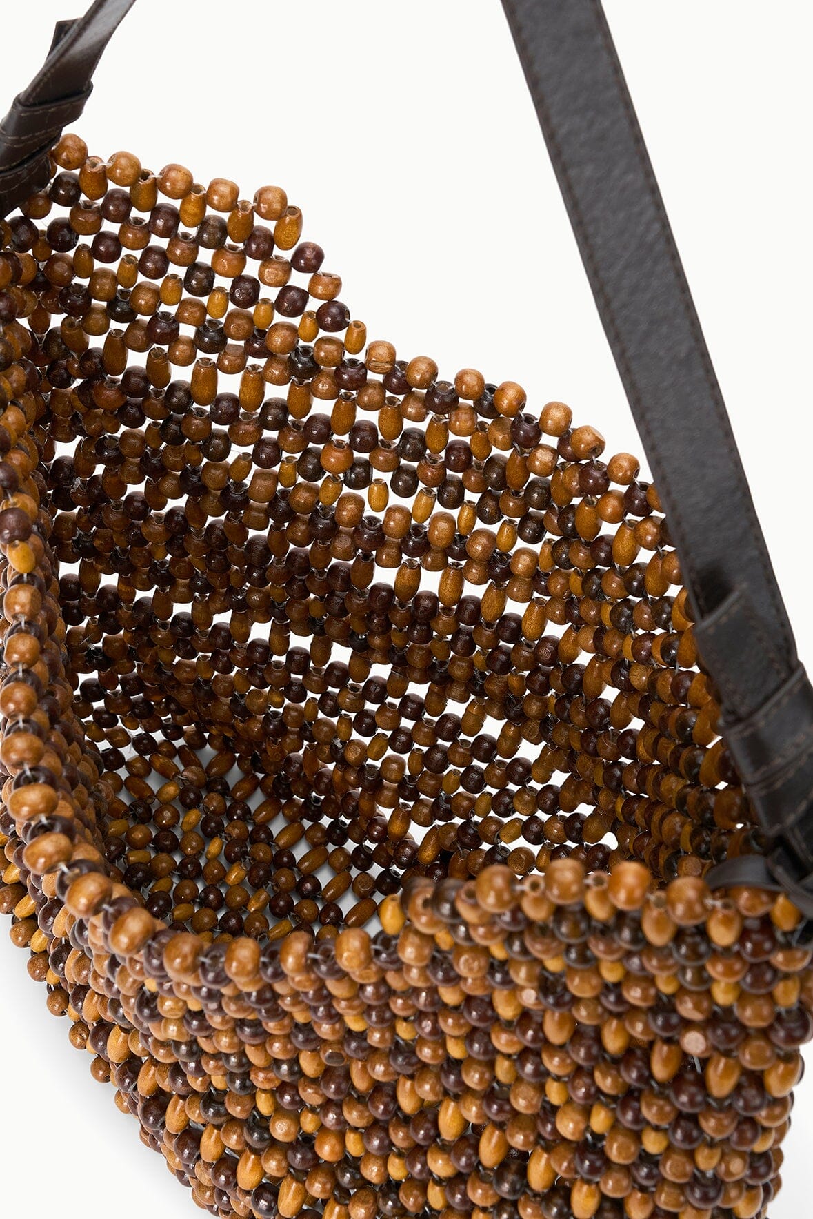 Detail of multi wood bead shoulder bag with black strap and woven bead texture