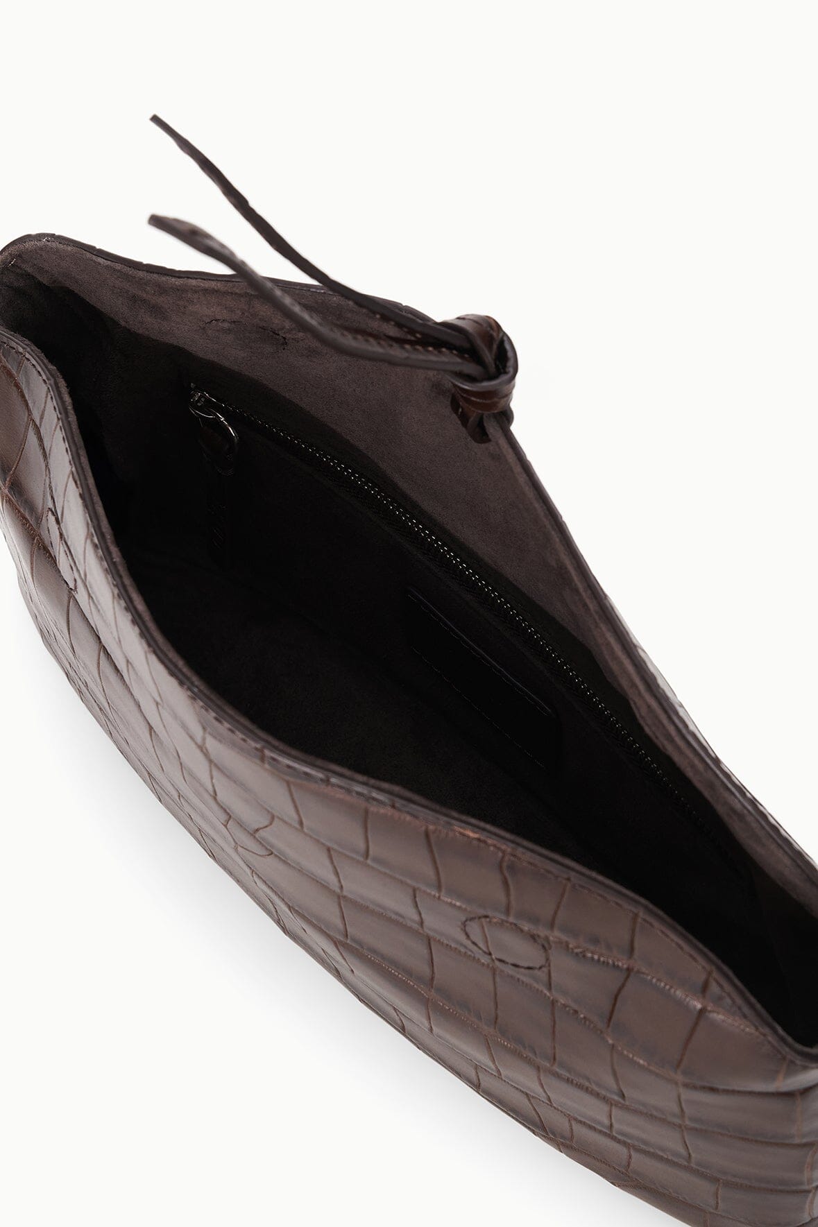 Croc-embossed clutch bag interior with black lining and zip closure