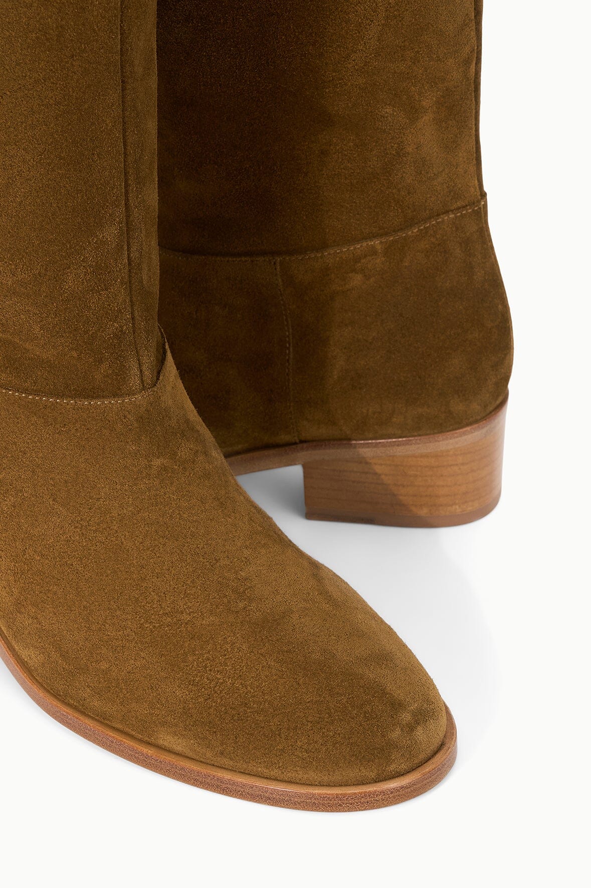 Cigar brown suede boot heel detail with wood-toned sole and stitched trim