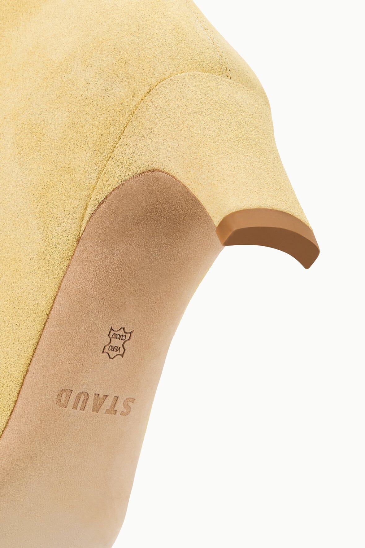 Butter boot heel and instep detail with logo stamp on suede
