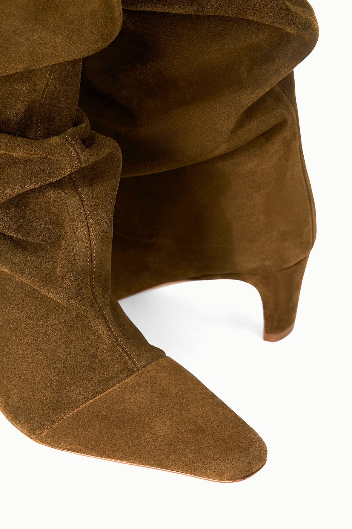 Cigar-brown suede slouch boot with pointed toe, stacked heel, and ruched fold