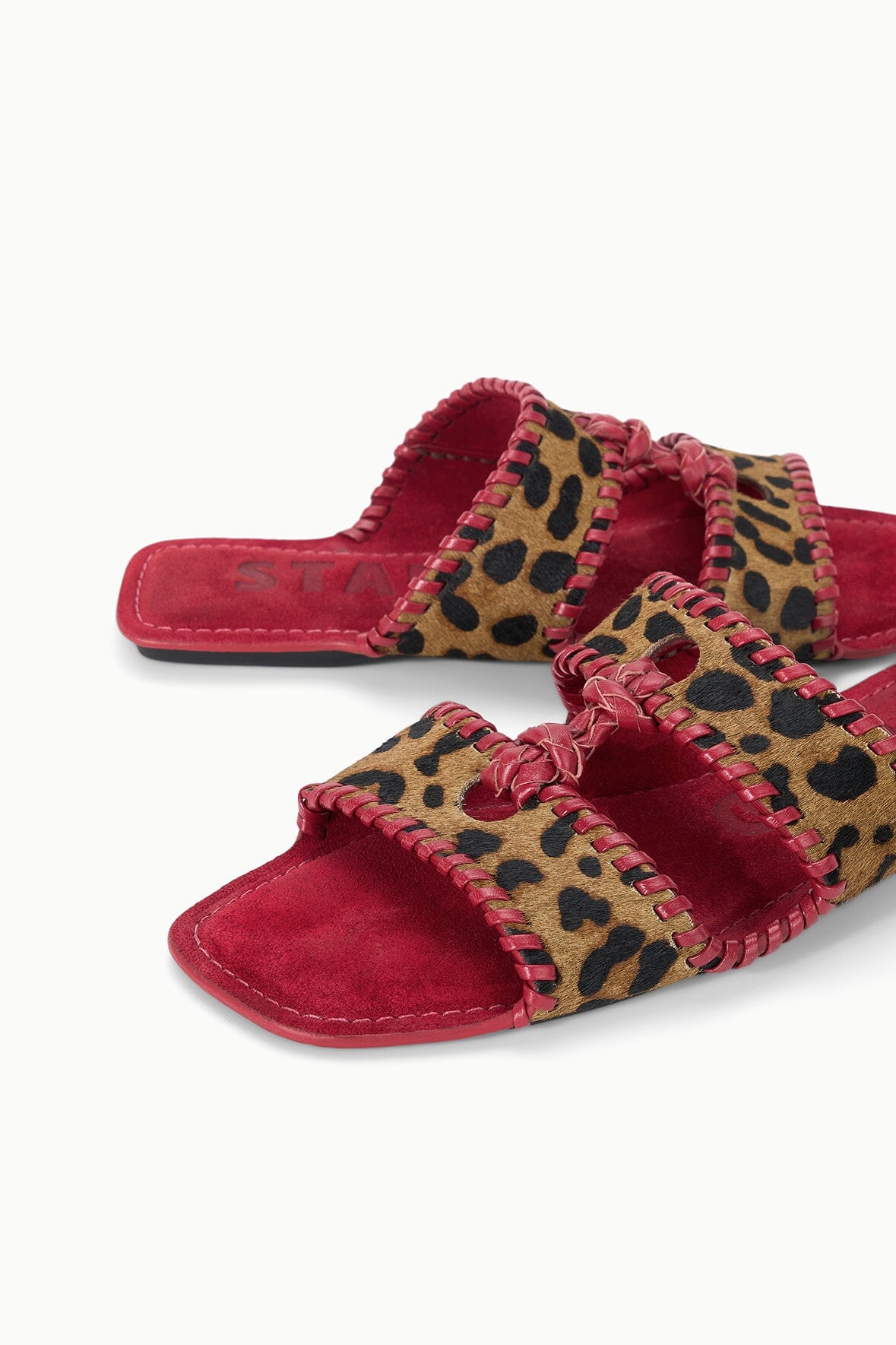 Pair of cheetah-print slide sandals with red footbed and ruffled strap trim
