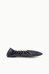 Black flat sneaker shoe, ruched upper with lace-up eyelets, side view