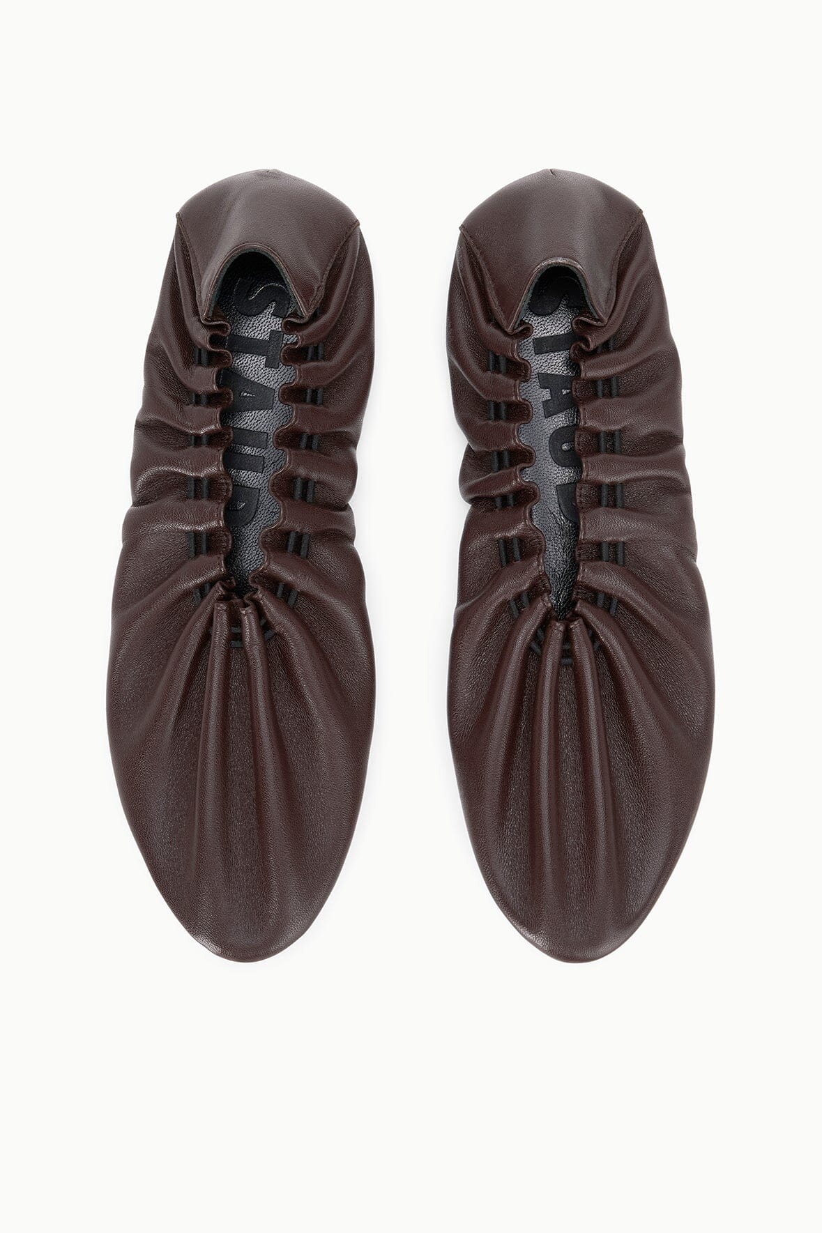 Espresso-brown flat lace-up shoes, top view showing eyelets and laces